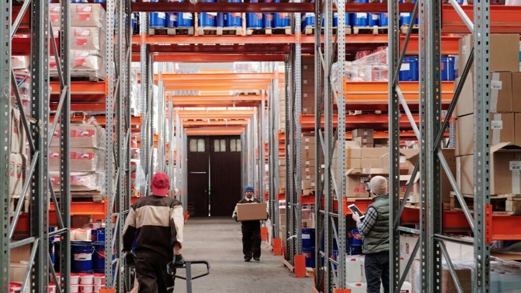 Warehousing operations with workers managing inventory, moving goods